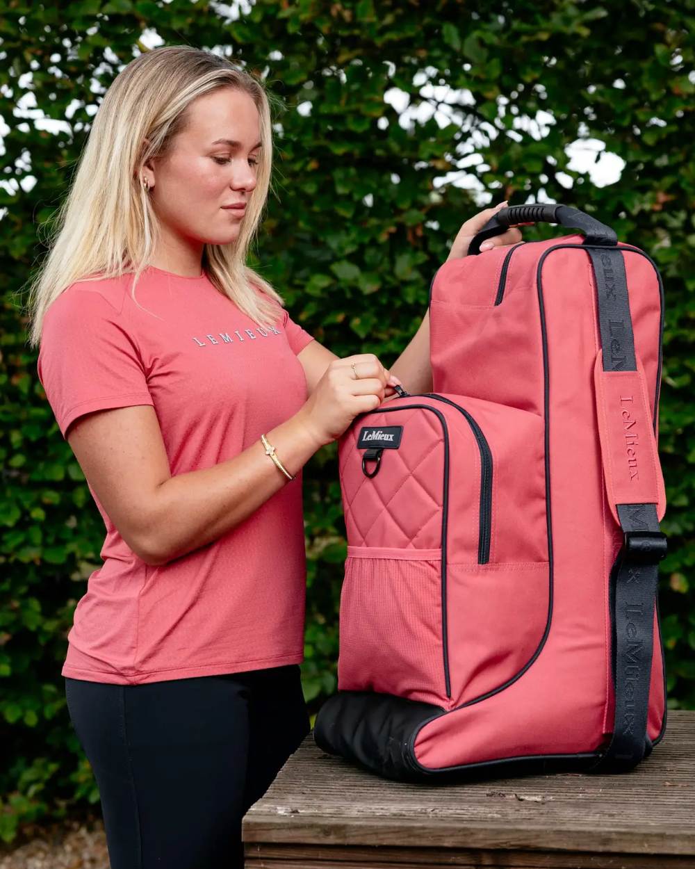 Cranberry coloured LeMieux Boot & Hat Bag on tree background