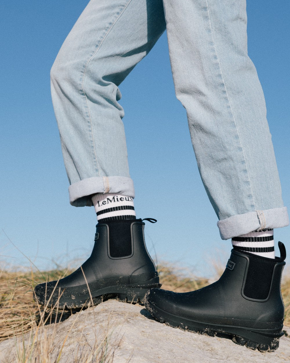 Black coloured LeMieux Bramshaw Chelsea Wellies on rock background