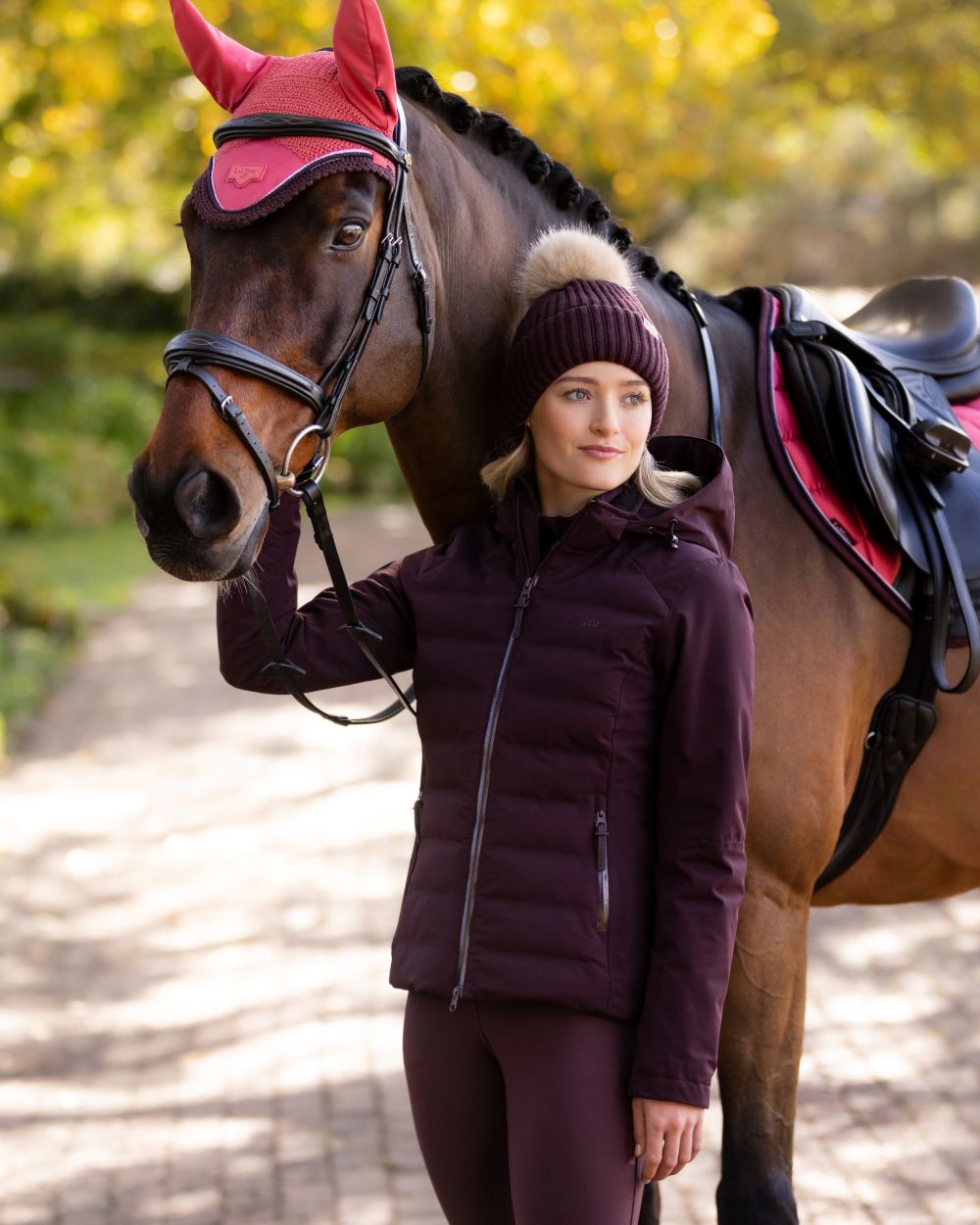 Damson coloured LeMieux Brooke Waterproof Hybrid Jacket on park background