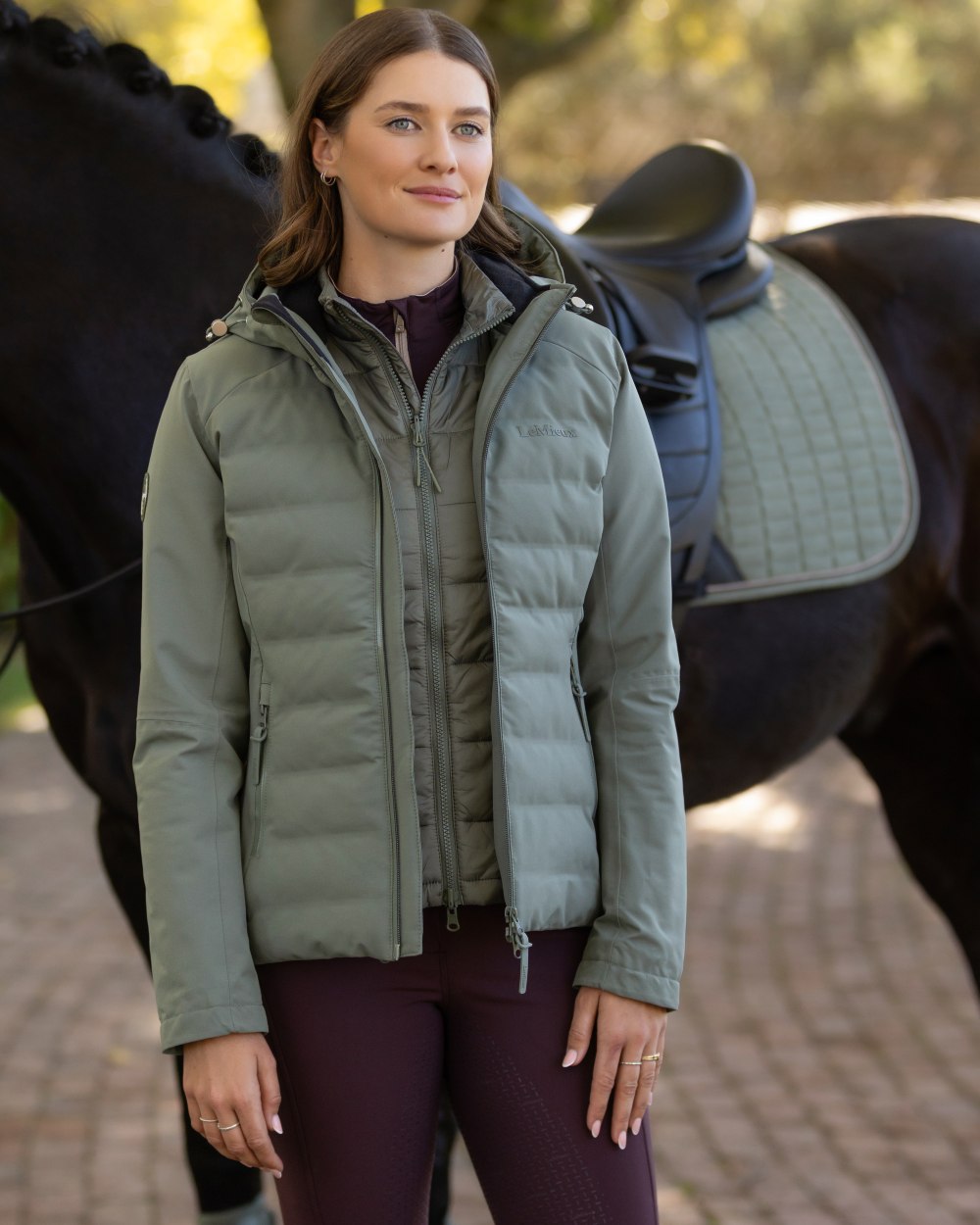 Rosemary coloured LeMieux Brooke Waterproof Hybrid Jacket on park background