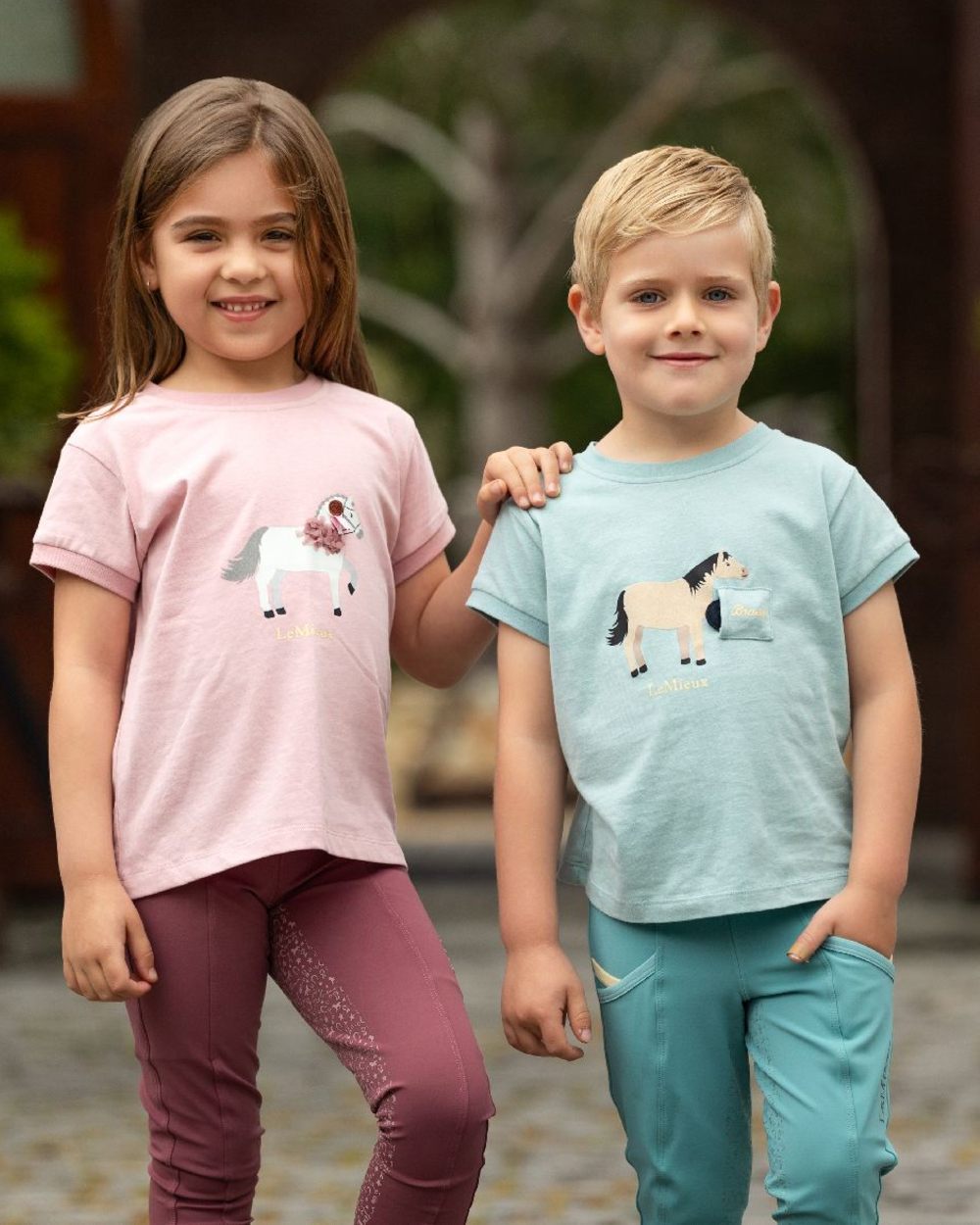 Aqua coloured LeMieux Childrens Mini Alex Tee on blurry background