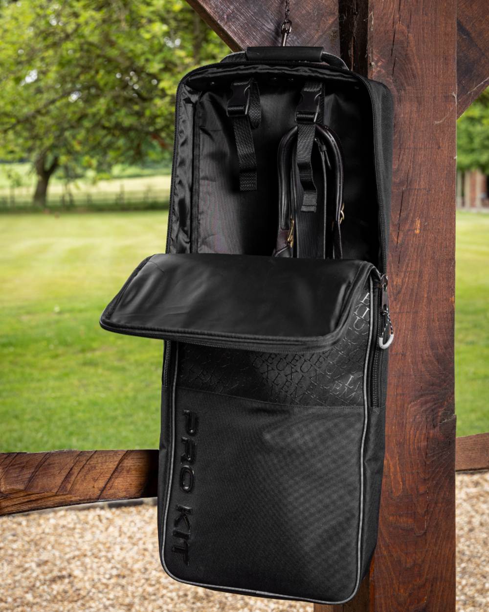 Black coloured LeMieux Elite Pro Bridle Bag on grass background