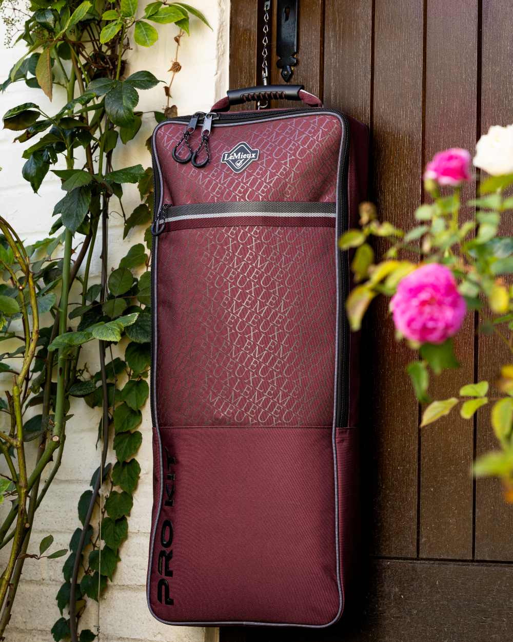 Burgundy coloured LeMieux Elite Pro Bridle Bag on outdoor background