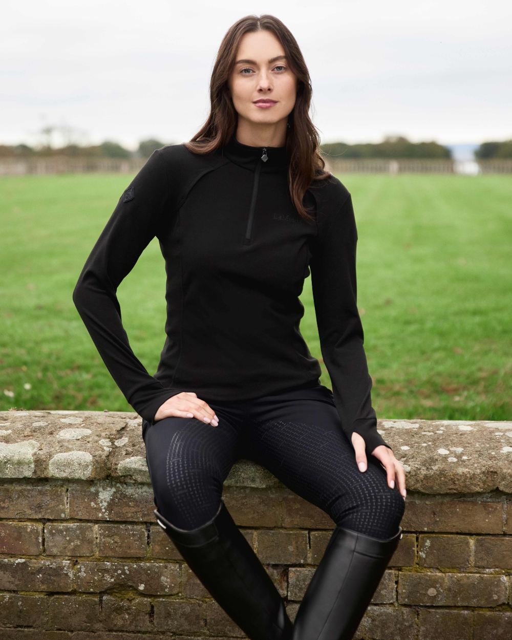 Black coloured LeMieux Frances Quarter Zip Fleece on grassy background