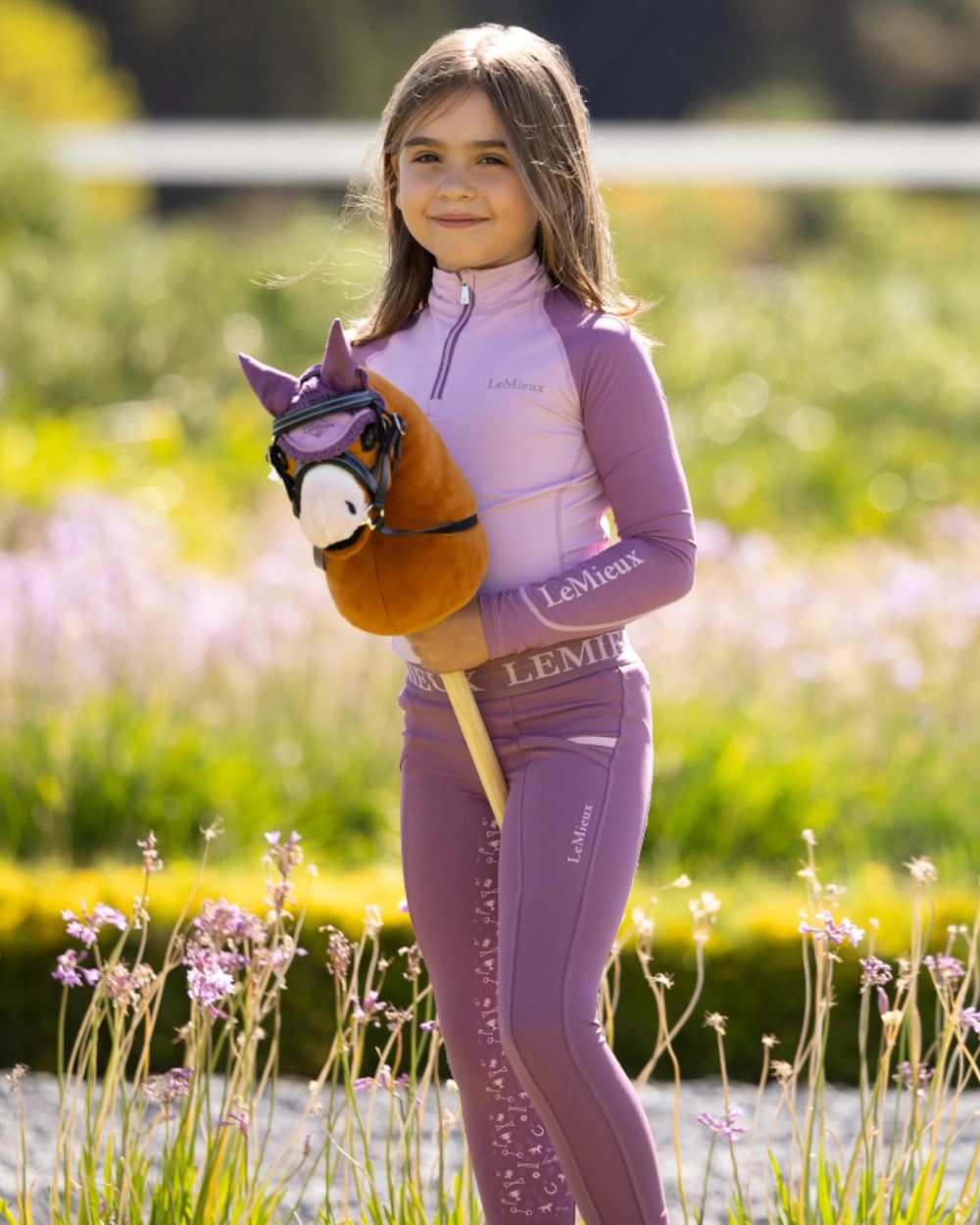 Sundance coloured LeMieux Hobby Horse Lite Sundance on garden background
