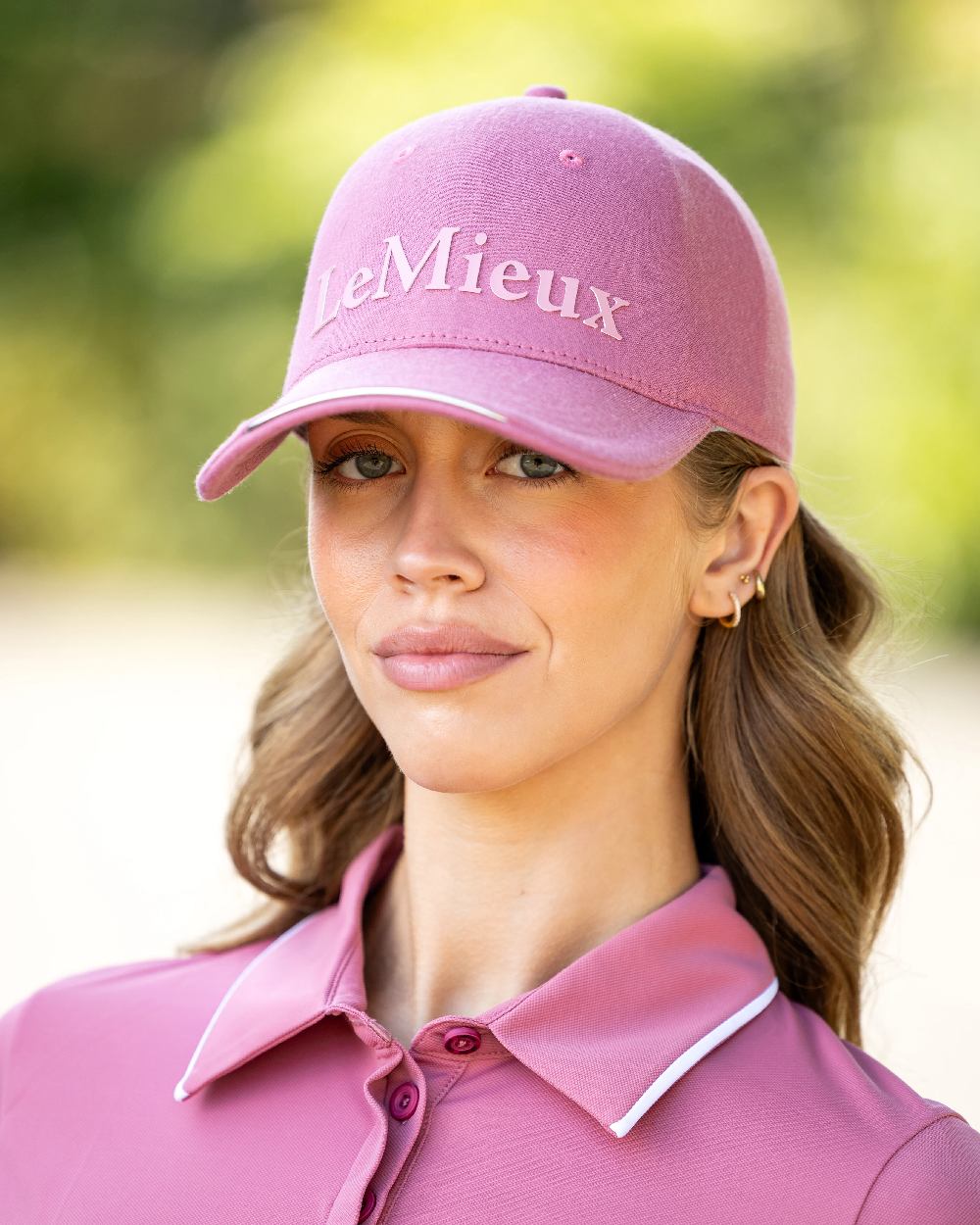 Blossom coloured LeMieux Lara Cap on blurry background
