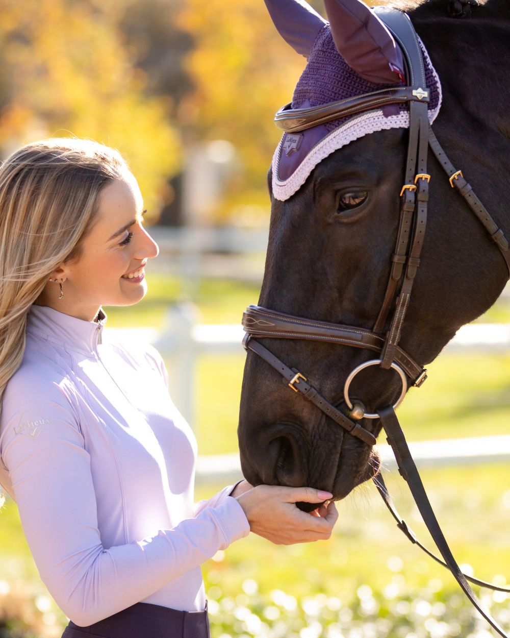 Juniper coloured LeMieux Loire Fly Hood on blurry background