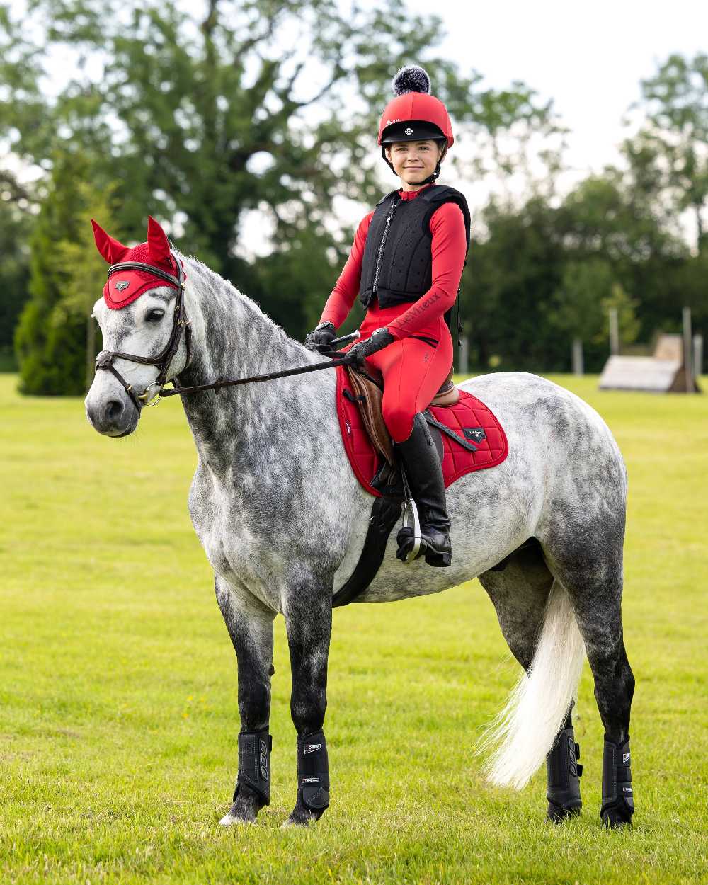 Chilli coloured LeMieux Loire GP Square Pad on yard background