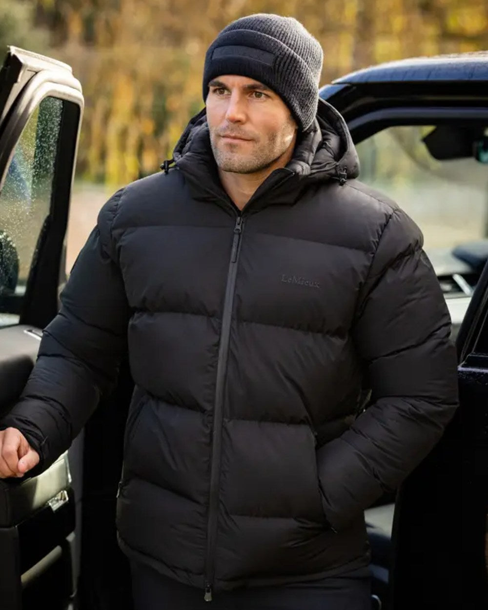 Black coloured LeMieux Mens Beanie on outdoor background