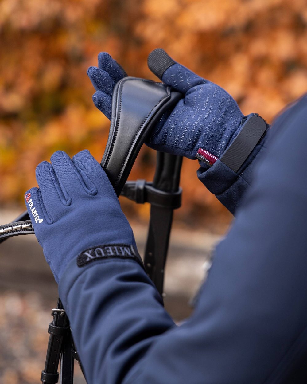Navy coloured LeMieux Polartec Gloves on blurry background