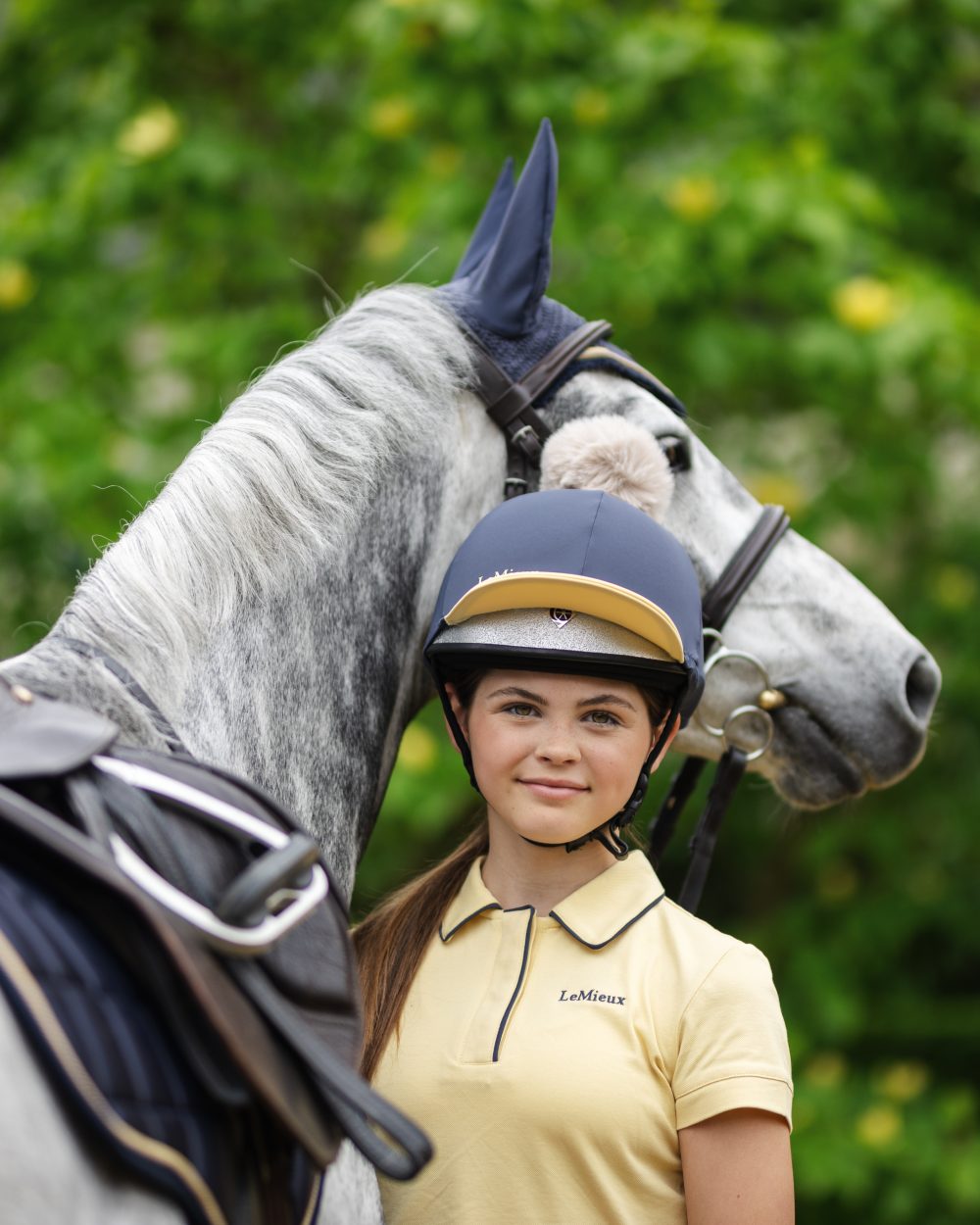 Dusk Mimosa coloured LeMieux Pom Hat Silk on blurry background