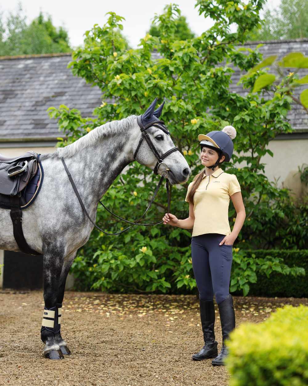 Dusk Mimosa coloured LeMieux Pom Hat Silk on backyard background
