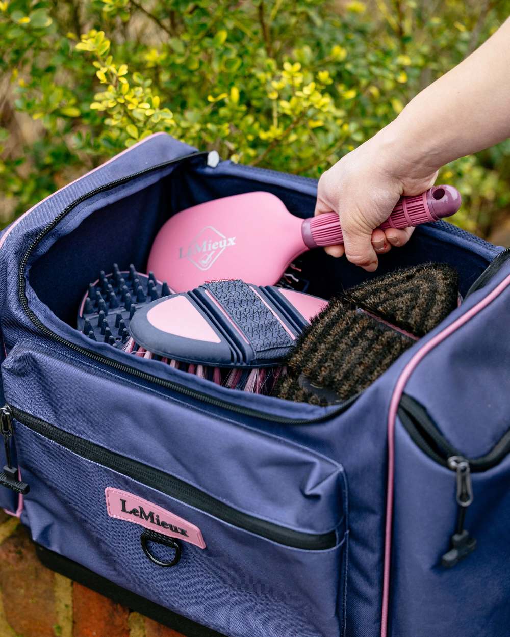 Dusk Blue coloured LeMieux ProKit Lite Grooming Bag on garden background