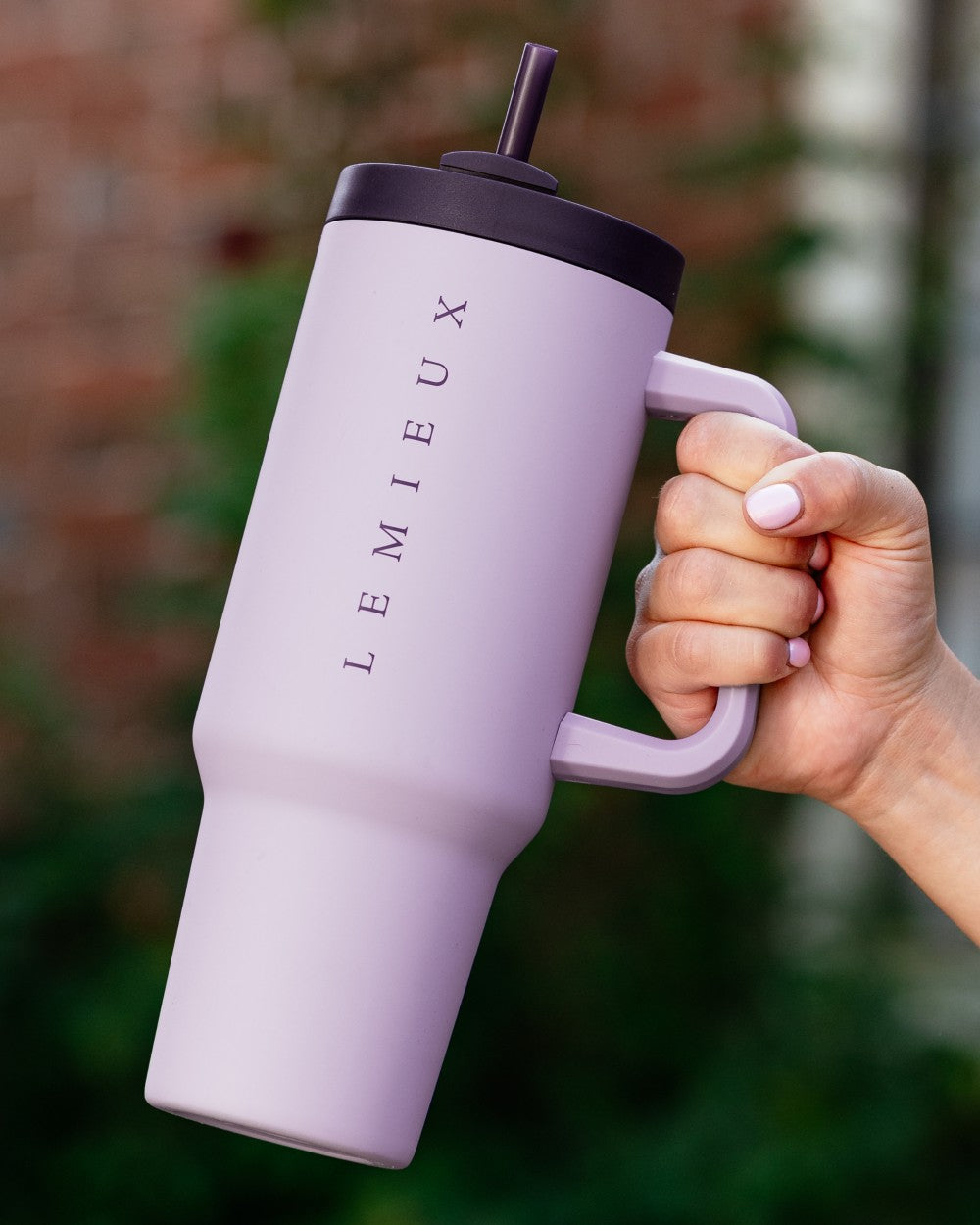 Lilac coloured LeMieux Sports Cup on blurry background