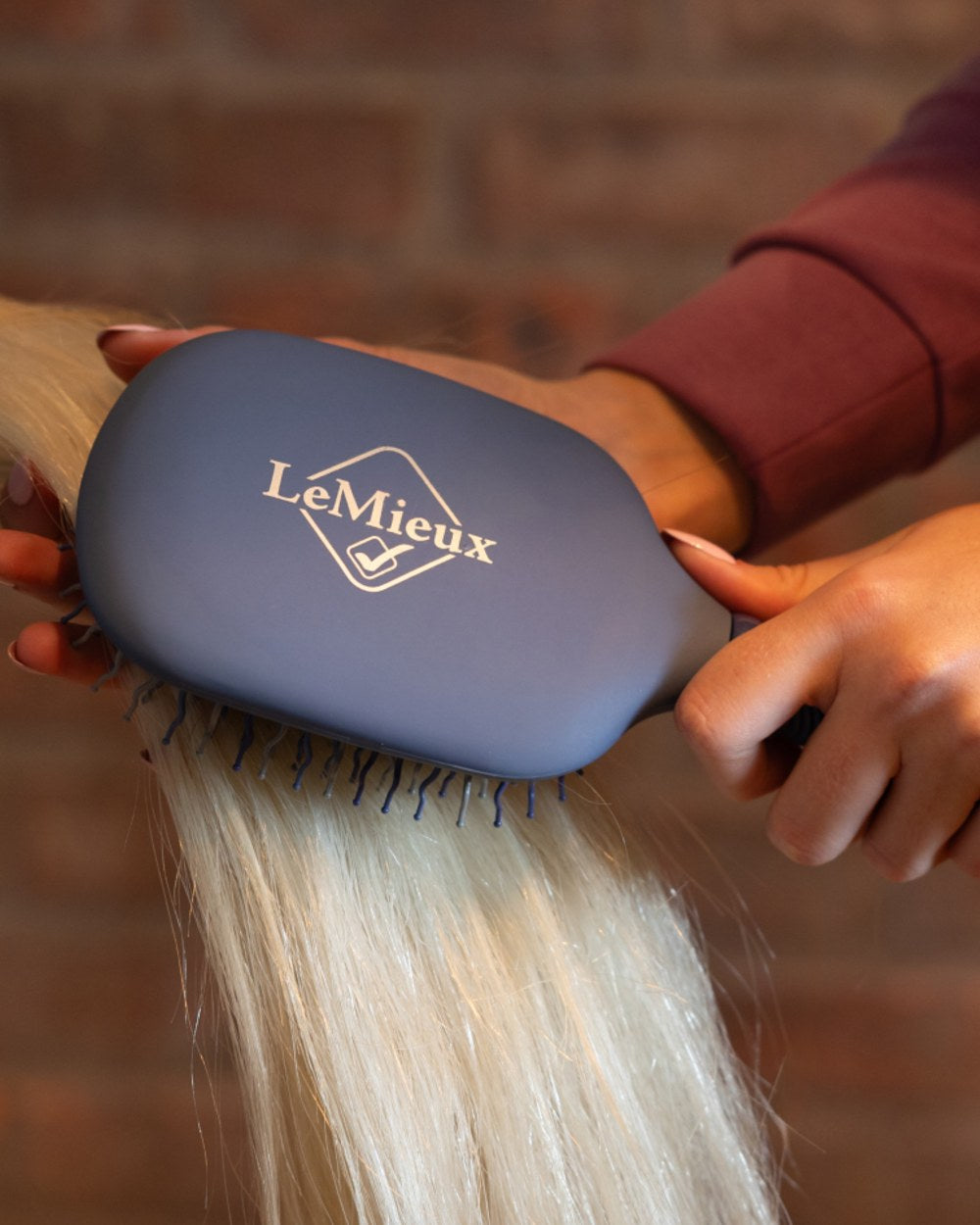 Powder Blue coloured LeMieux Tangle Tidy Brush on outdoor background
