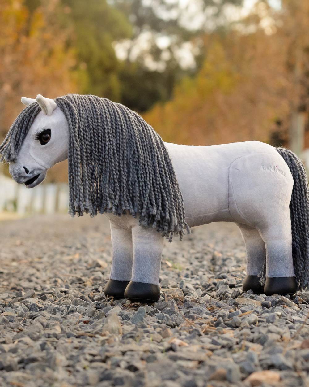 Blanca coloured LeMieux Toy Pony Blanca on tree background