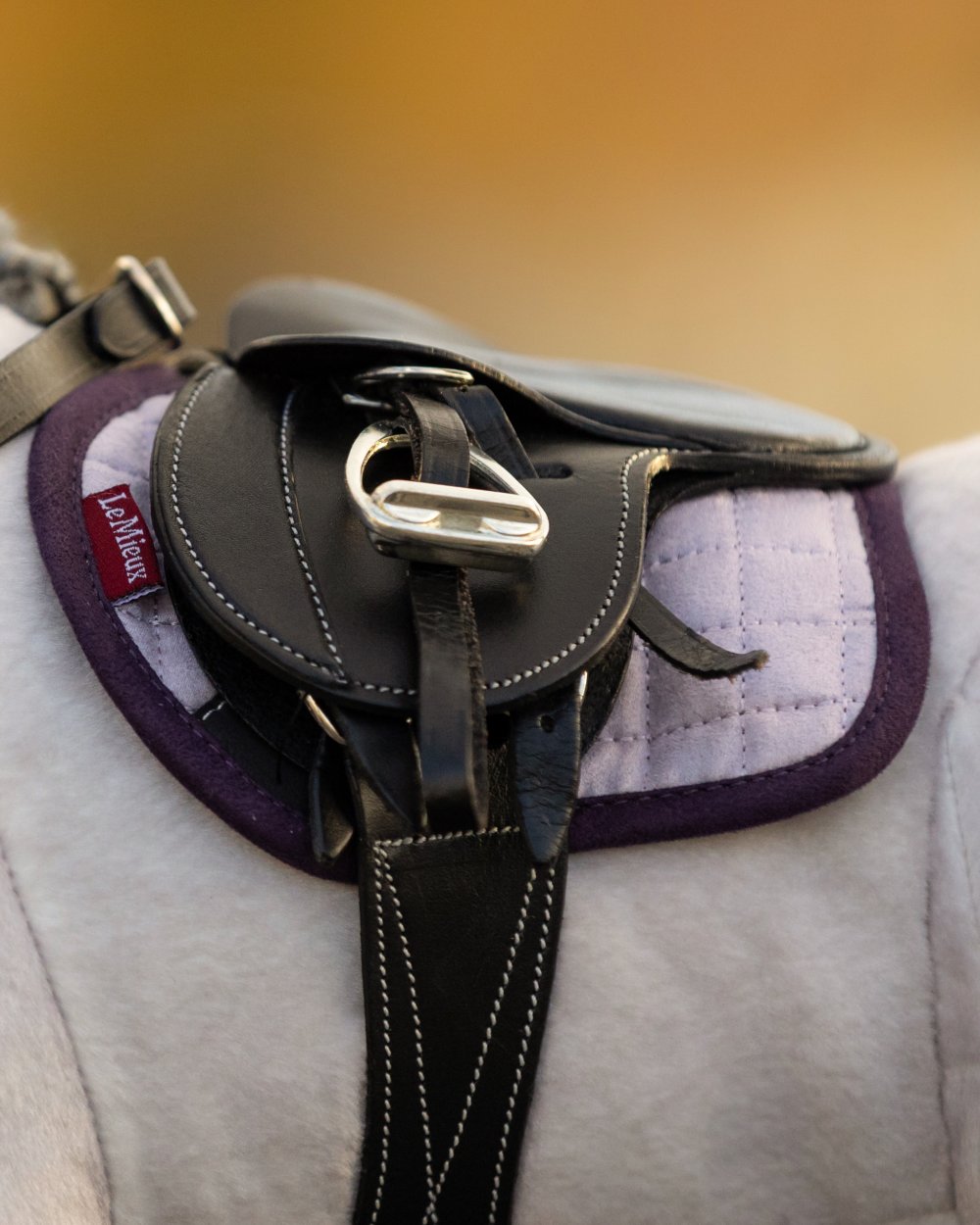 Lilac Coloured LeMieux Toy Pony Pad On A Blurry Background