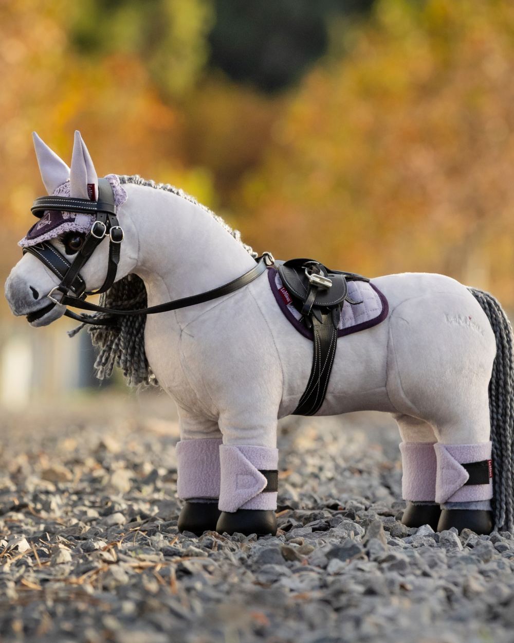 Lilac Coloured LeMieux Toy Pony Pad On A Blurry Background
