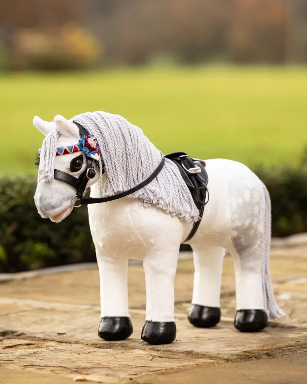 Brown coloured LeMieux Toy Pony Showing Numnah Brown on garden background