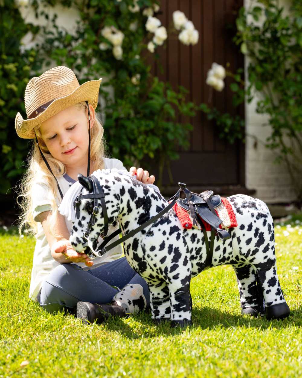 Black coloured LeMieux Toy Pony Western Bridle on grass background
