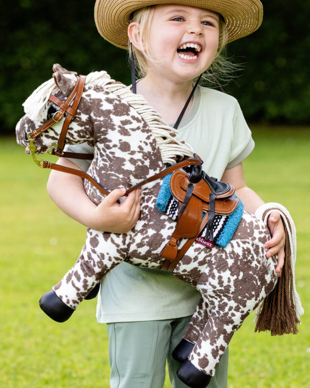 Azure coloured LeMieux Toy Pony Western Pad on blurry green background