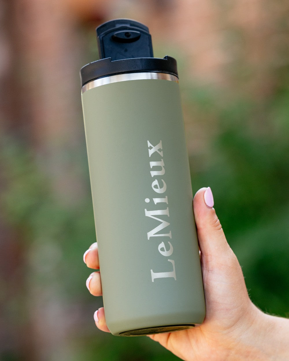 Rosemary Coloured LeMieux Travel Cup On A Blurry Background