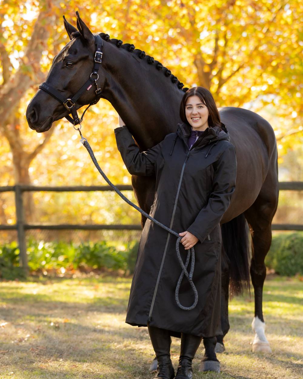 Black coloured LeMieux Womens All Elements Robe Coat on outdoor background