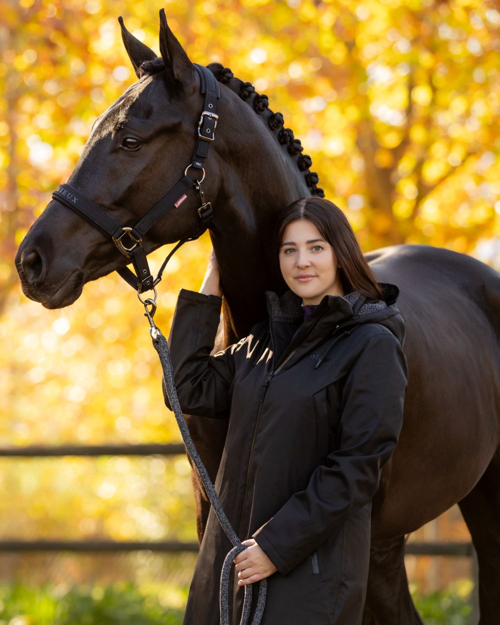 Black coloured LeMieux Womens All Elements Robe Coat on outdoor background