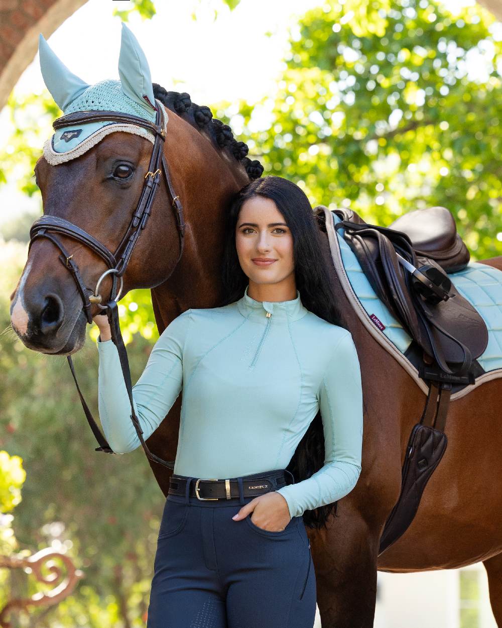 Aqua coloured LeMieux Womens Base Layer on blurry background