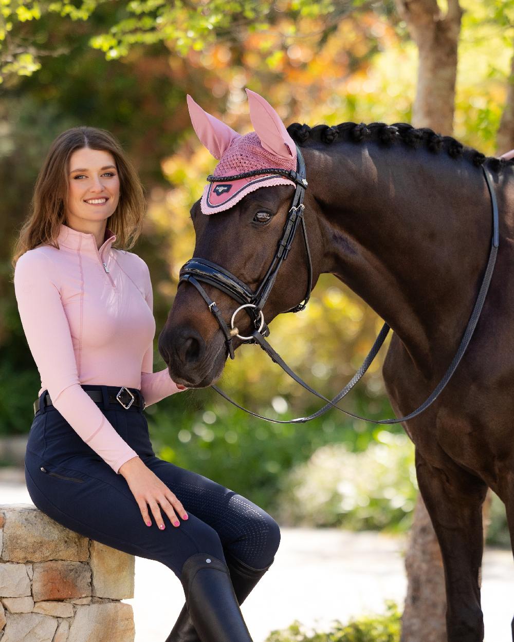 Blossom coloured LeMieux Womens Base Layer on backyard background