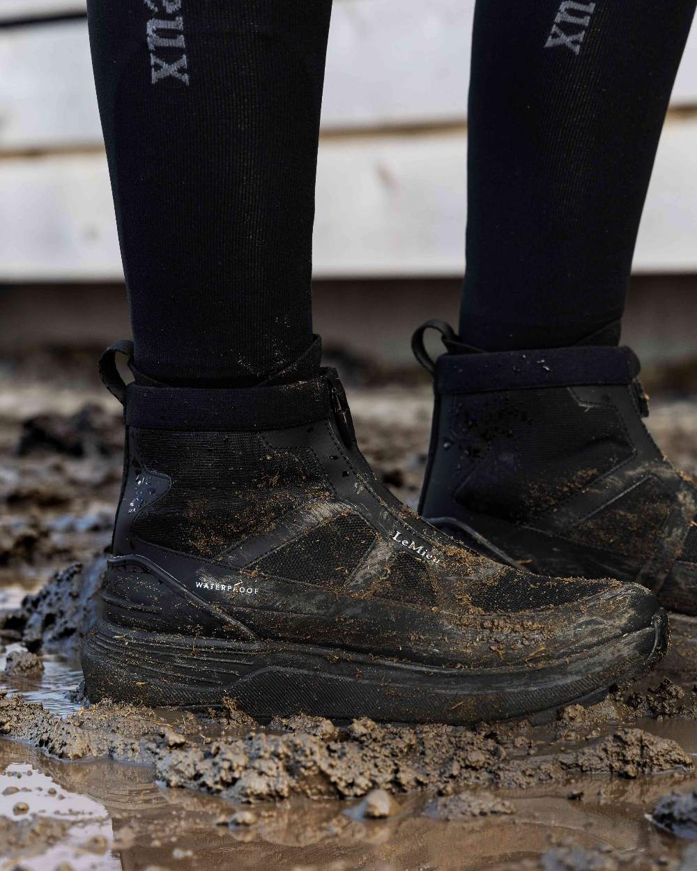 Black Coloured LeMieux Womens Cavara Performance high Top Trainer on White Background