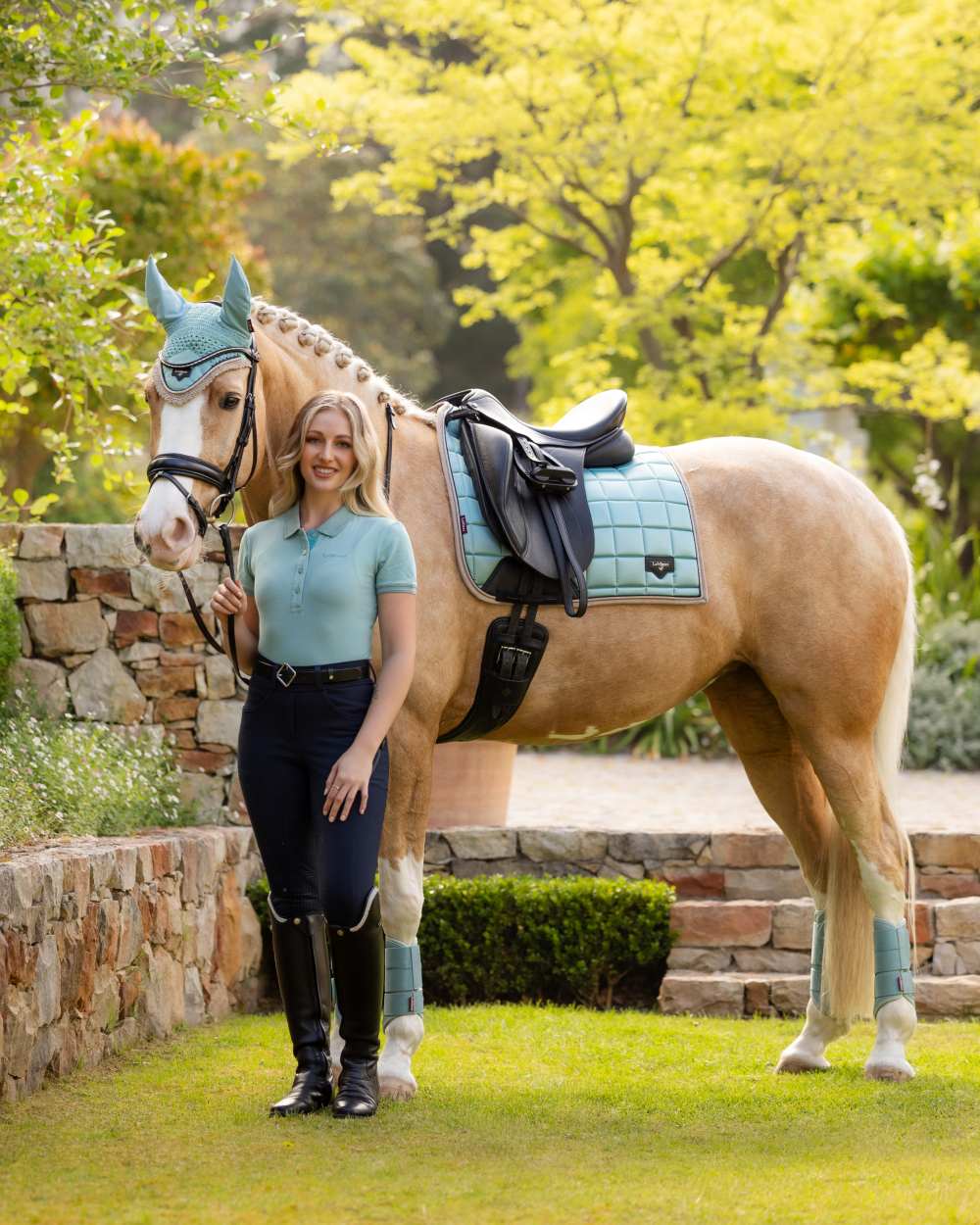 Aqua coloured LeMieux Womens Classique Polo Shirt on backyard background