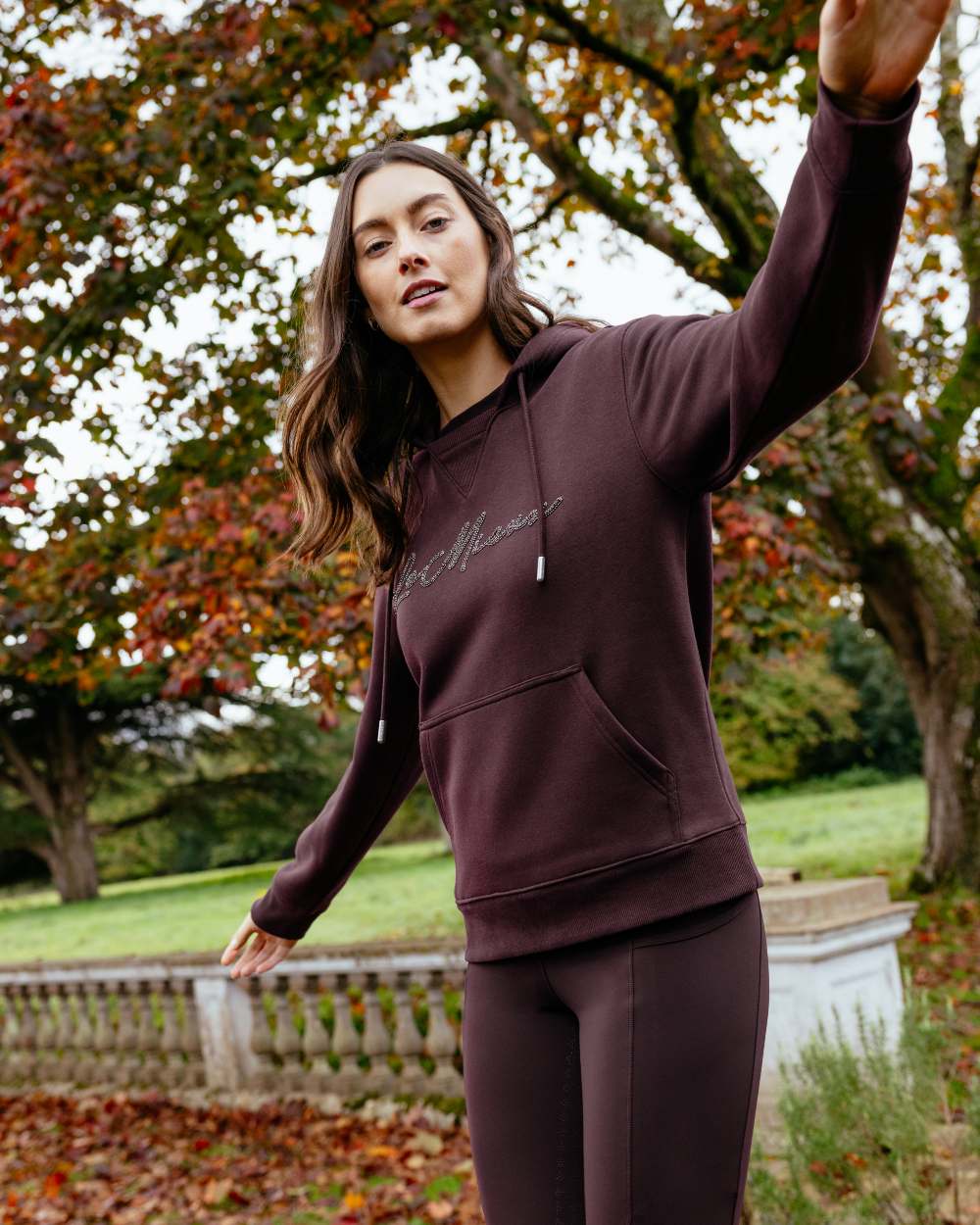 Damson coloured LeMieux Womens Elspeth Hoodie on garden background