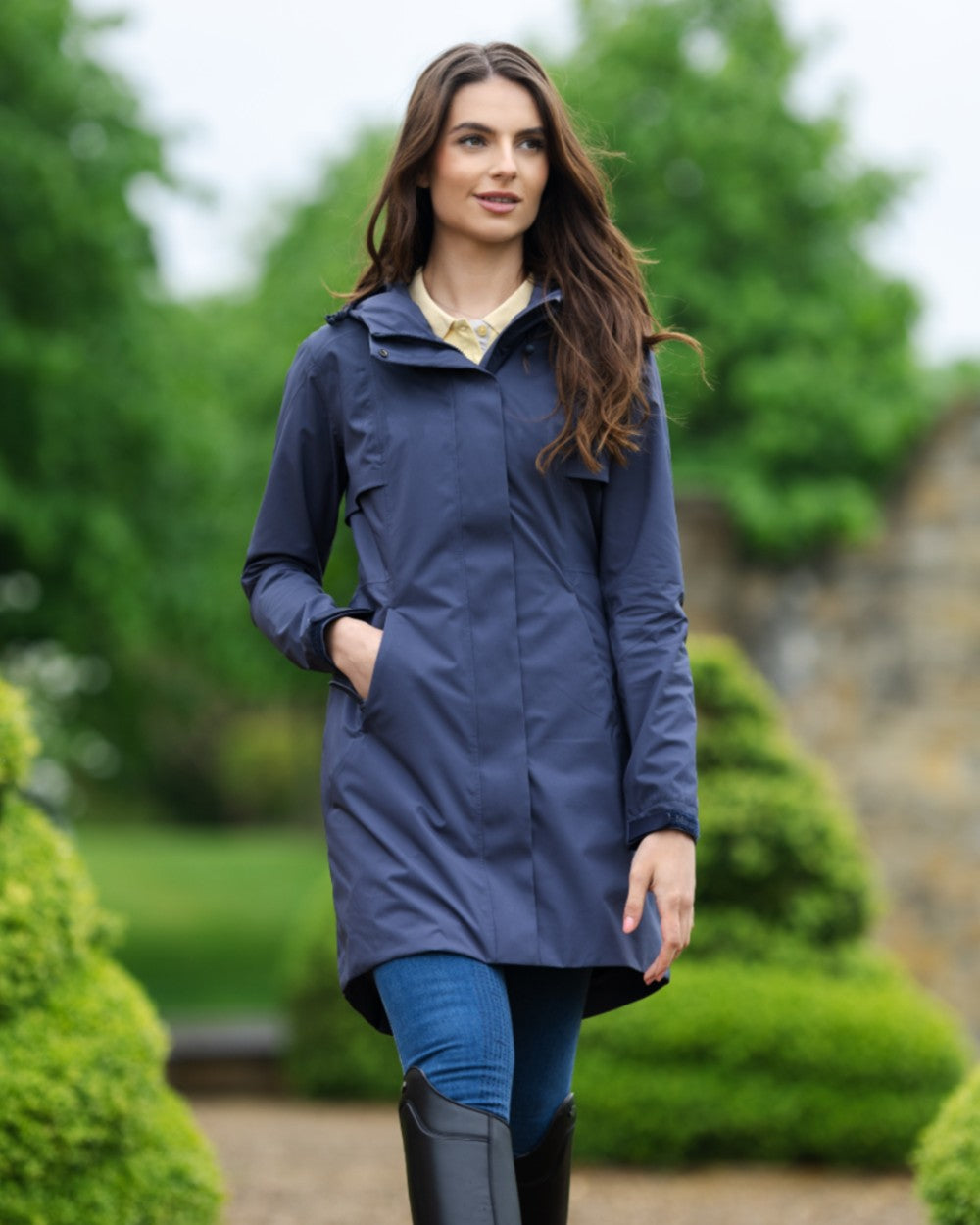 Dusk Blue coloured LeMieux Womens Grace Long Rain Jacket on blurry background