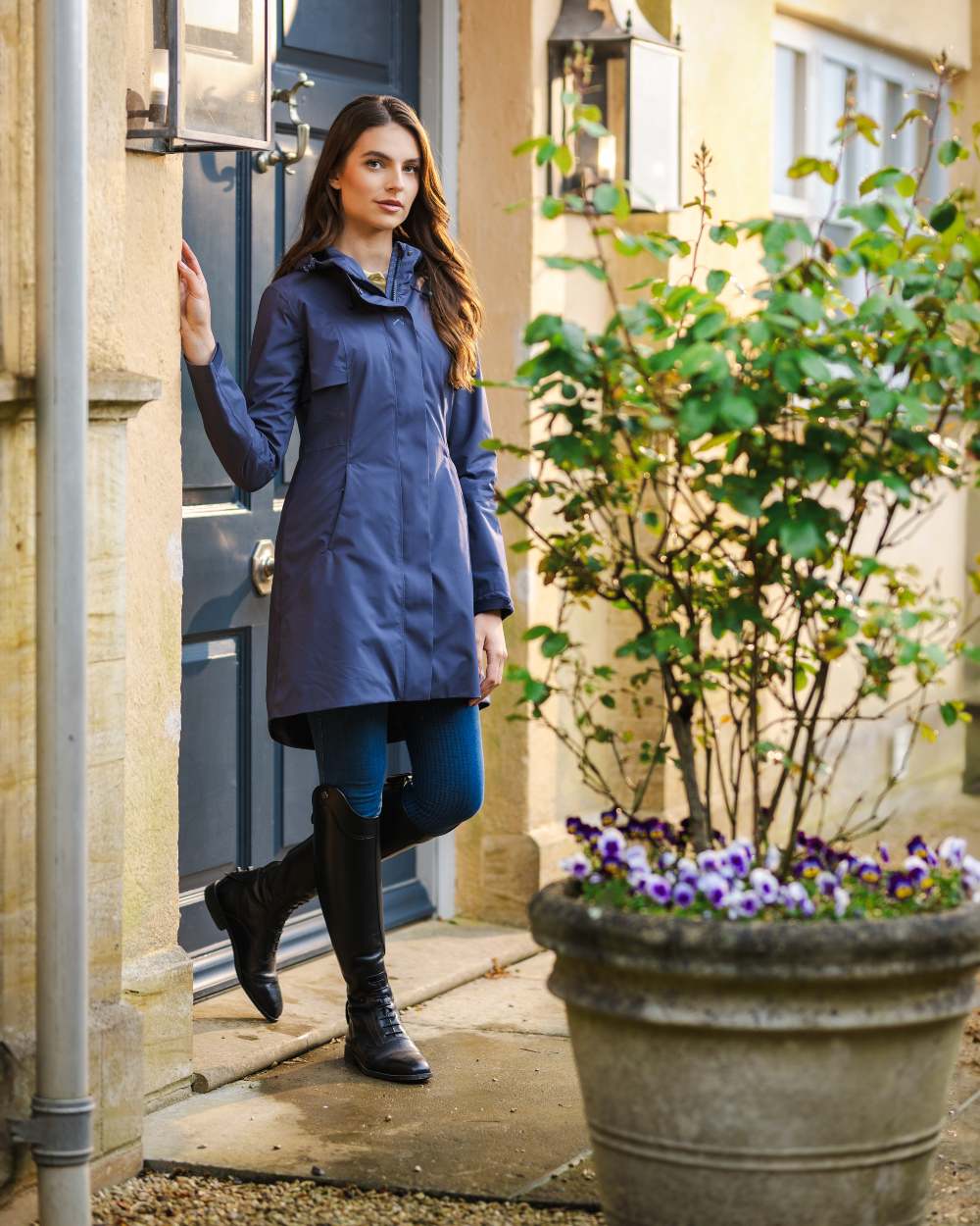 Dusk Blue coloured LeMieux Womens Grace Long Rain Jacket on street background