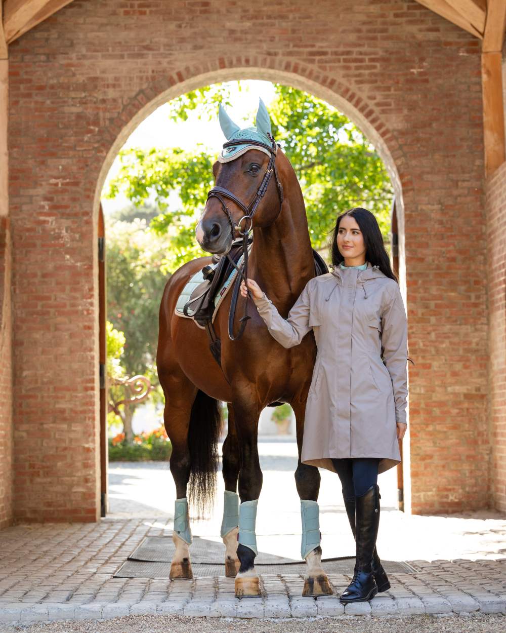 Pecan coloured LeMieux Womens Grace Long Rain Jacket on street background