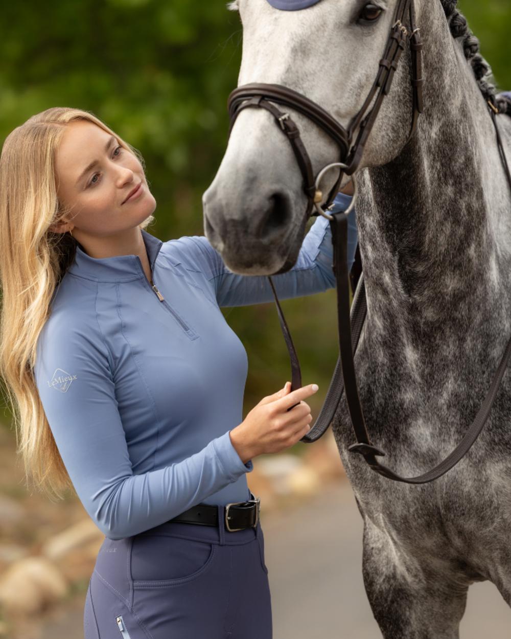 Powder Blue coloured LeMieux Womens Halle Lightweight Base Layer on outdoor background