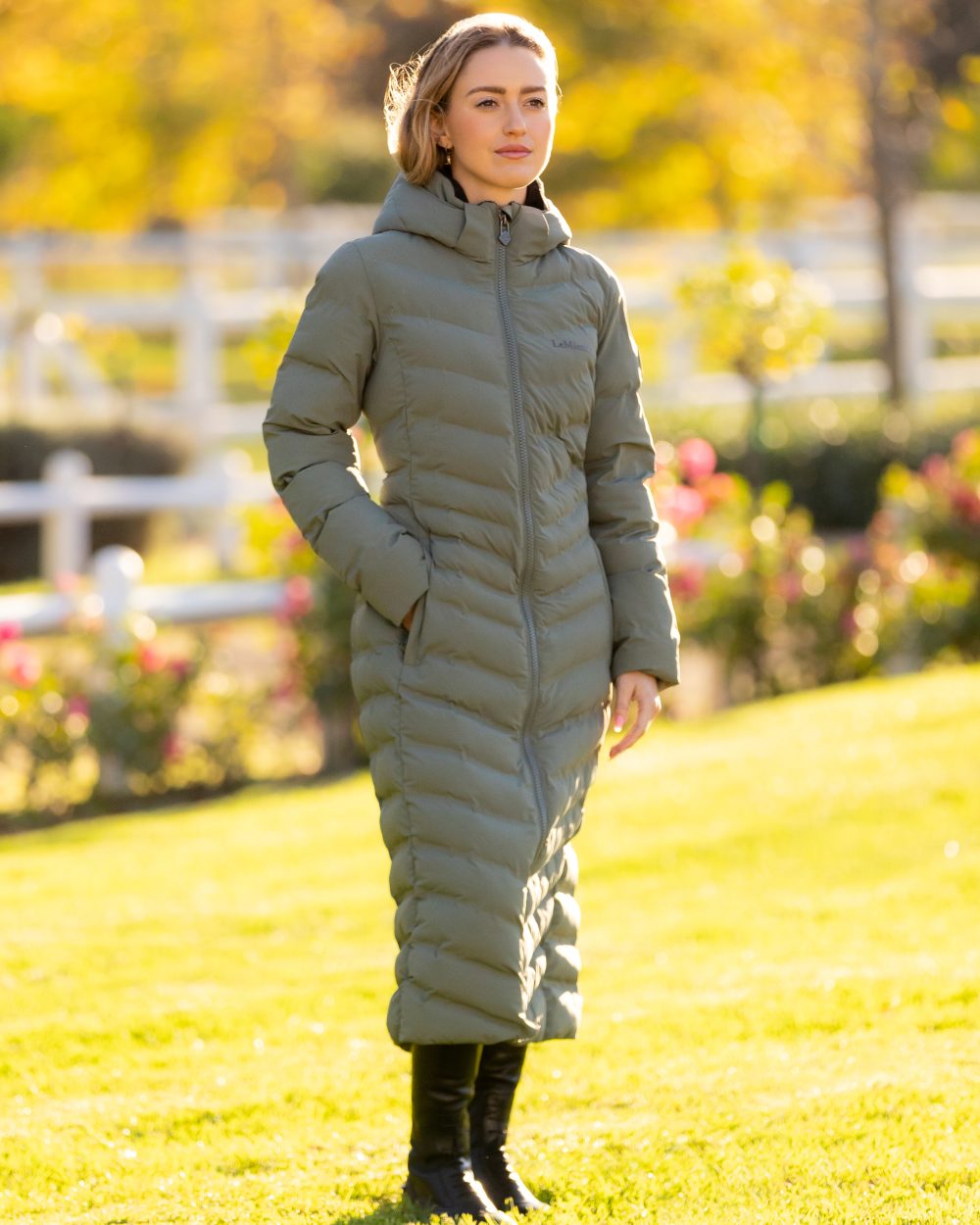 Rosemary coloured LeMieux Womens Hayley Water Resistant Longline Puffer Coat on park background