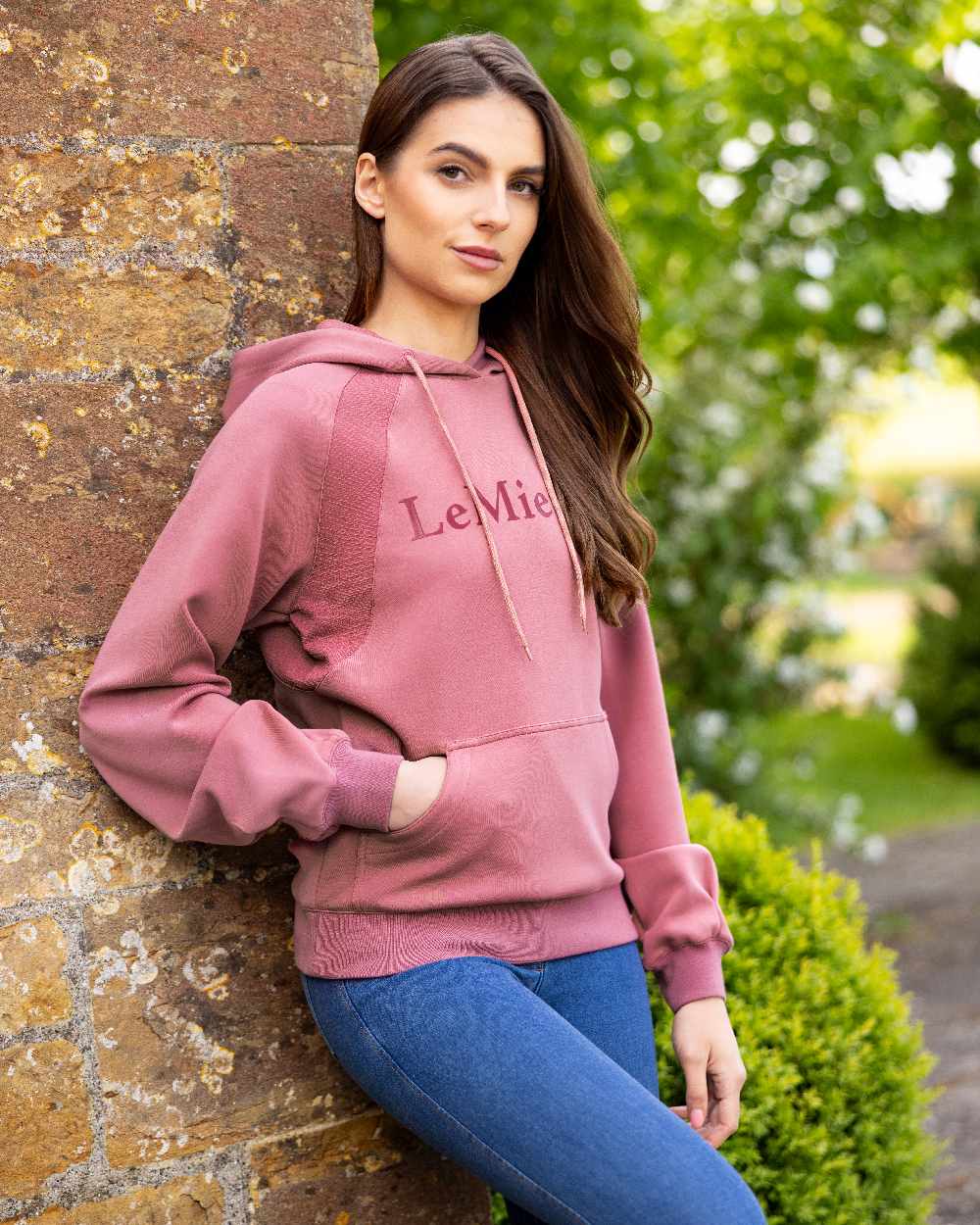 Peony coloured LeMieux Womens Nadine Hoodie on wall background