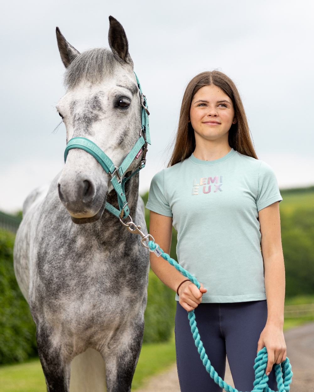 Aqua coloured LeMieux Young Rider Arianna T-Shirt on street background