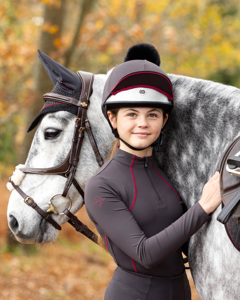 Cinder coloured LeMieux Young Rider Base Layer on blurry background