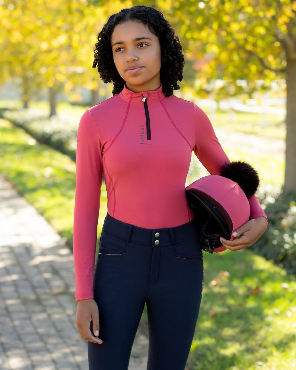 Cranberry coloured LeMieux Young Rider Classique Base Layer on tree background
