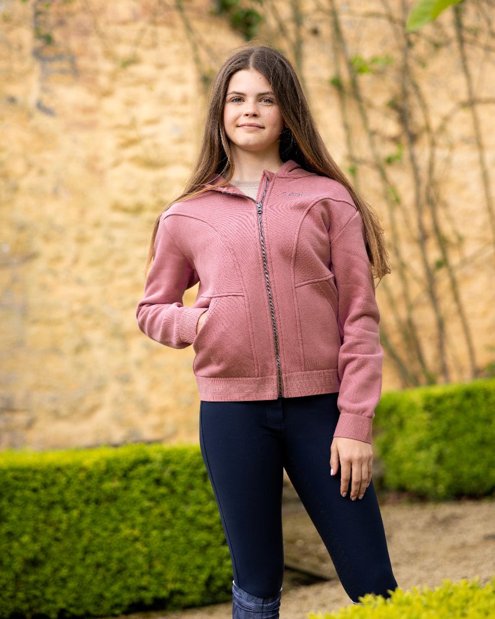 Peony coloured LeMieux Young Rider Hadley Hoodie on backyard background