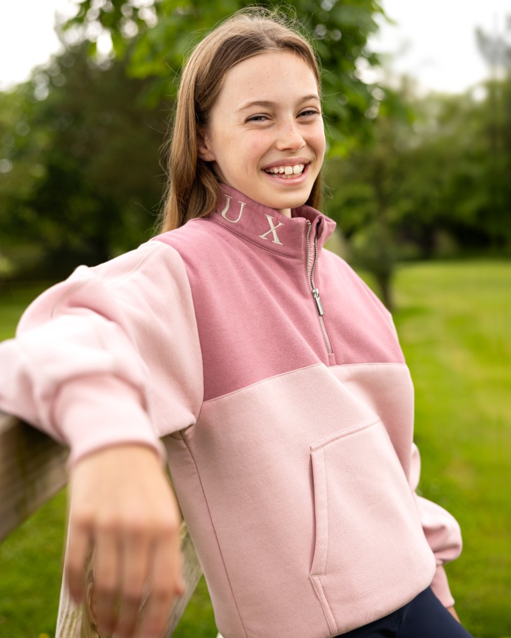 Blossom coloured LeMieux Young Rider Kate Quarter Zip Sweater on lawn background