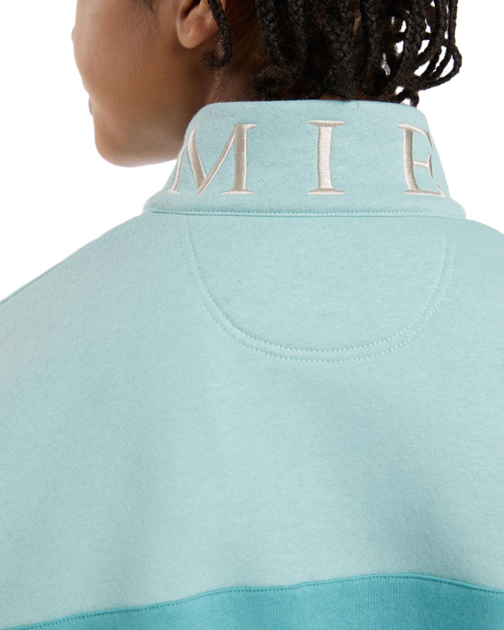 Lagoon coloured LeMieux Young Rider Kate Quarter Zip Sweater on white background