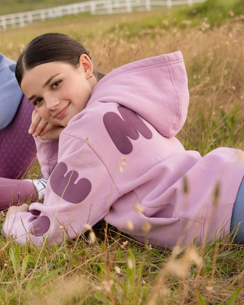 Fondant coloured LeMieux Young Rider Sia Hoodie on grass background