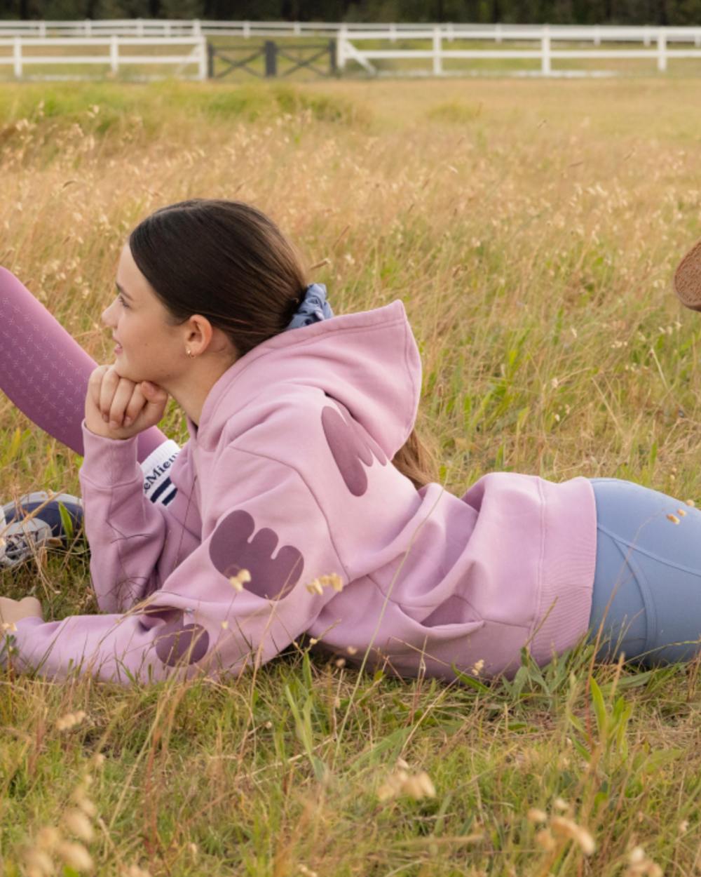 Fondant coloured LeMieux Young Rider Sia Hoodie on grass background