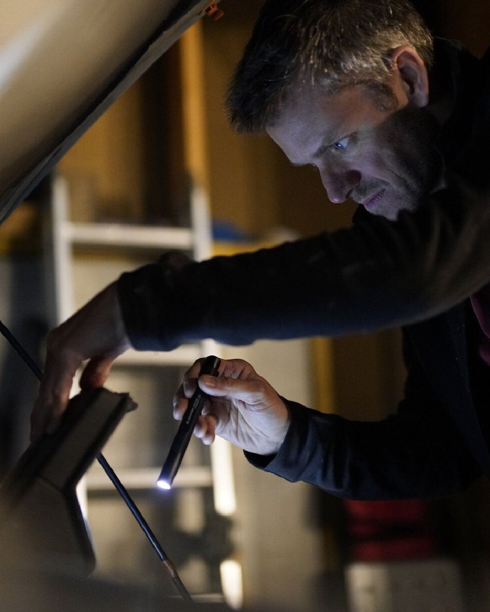 Black coloured Led Lenser P4R Core Rechargeable Torch on blurry background