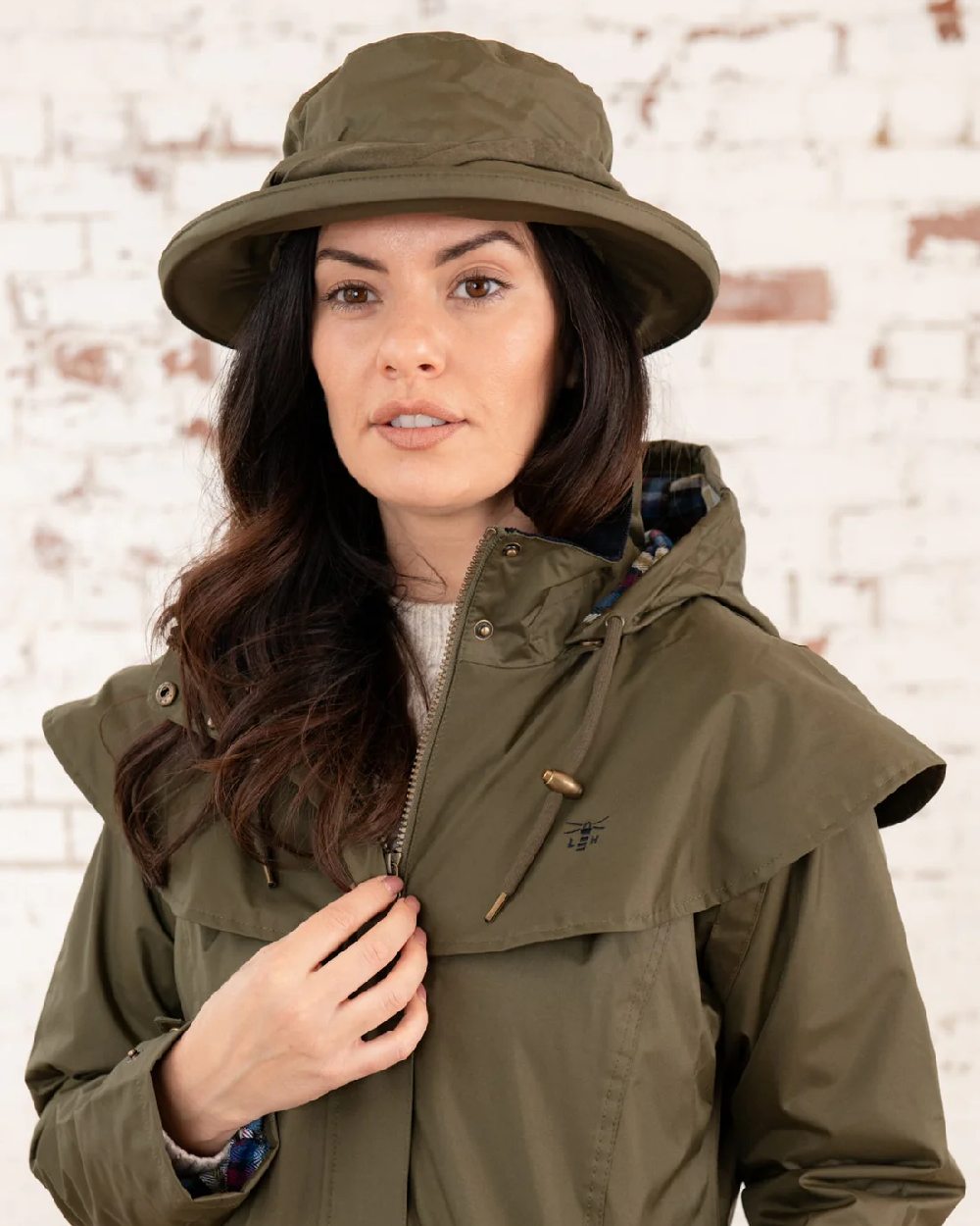 Fern coloured Lighthouse Canterbury Waterproof Hat on wall background