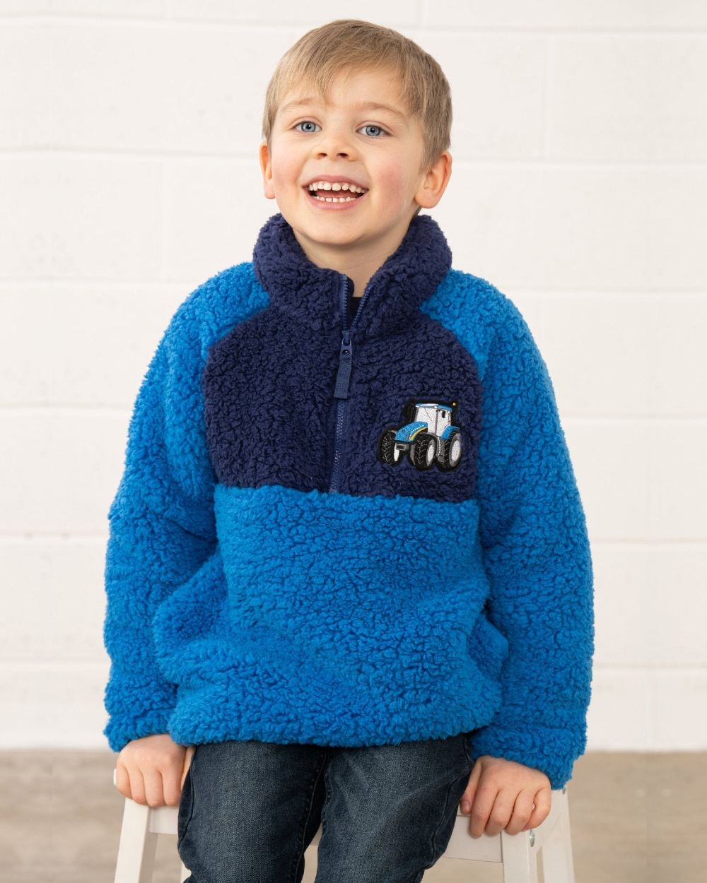 Blue Tractor coloured Lighthouse Childrens Caden Fleece on wall background